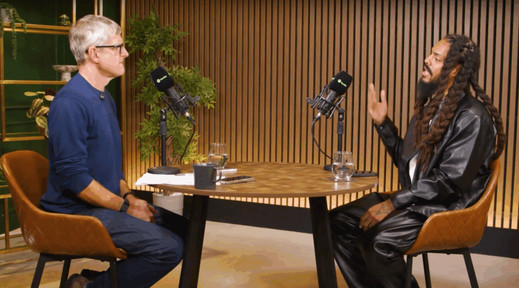 A photo of Theroux and Vylan seated at a table.