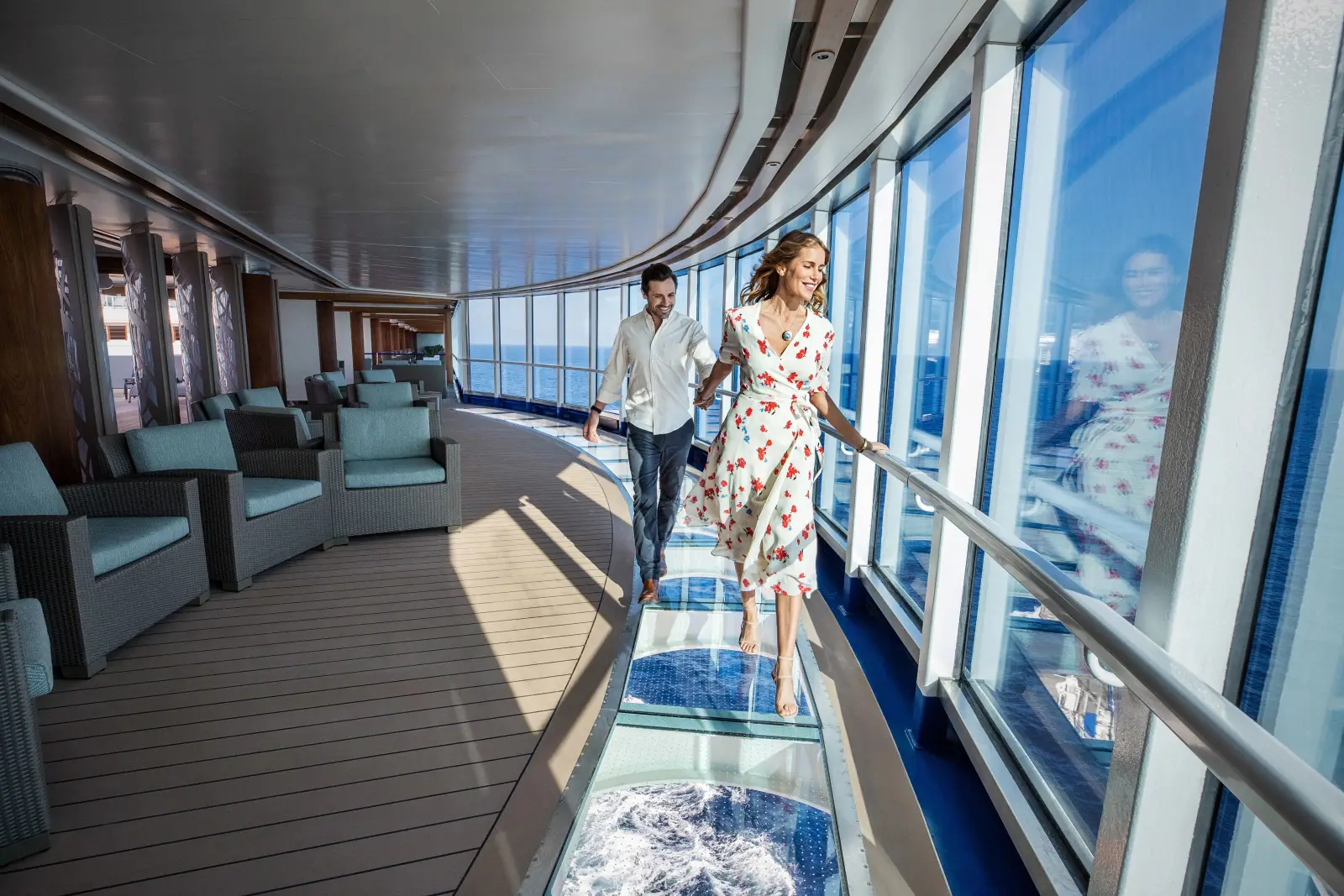 Couple walking on the glass SeaWalk aboard Discovery Princess cruise ship