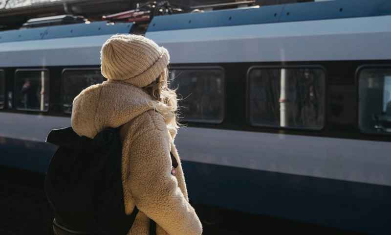 Female traveller at the train station, exploring Europe by train