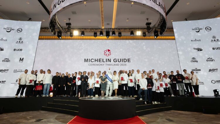 A large group of chefs and representatives stand on stage during the MICHELIN Guide Ceremony Thailand 2026, celebrating new award recipients.