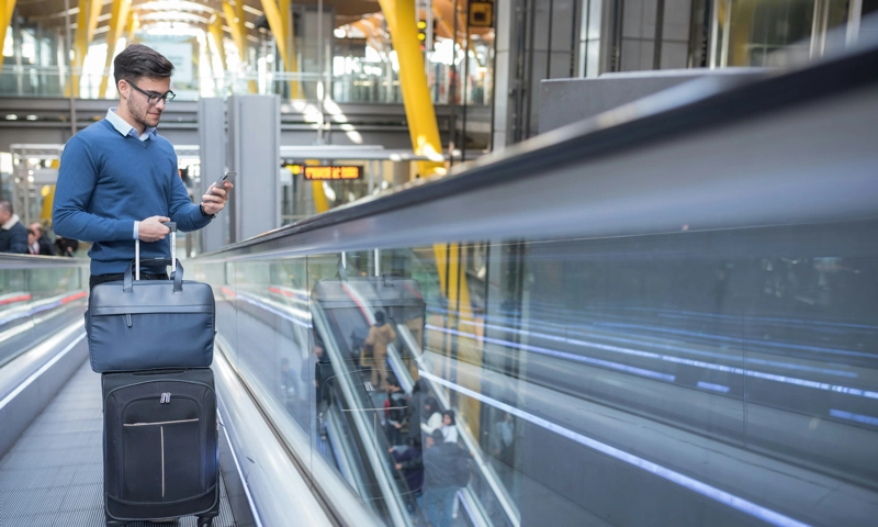 A man on an escalator at an airport