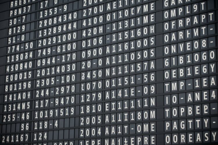 A busy airport terminal showing passengers waiting for timely boarding.