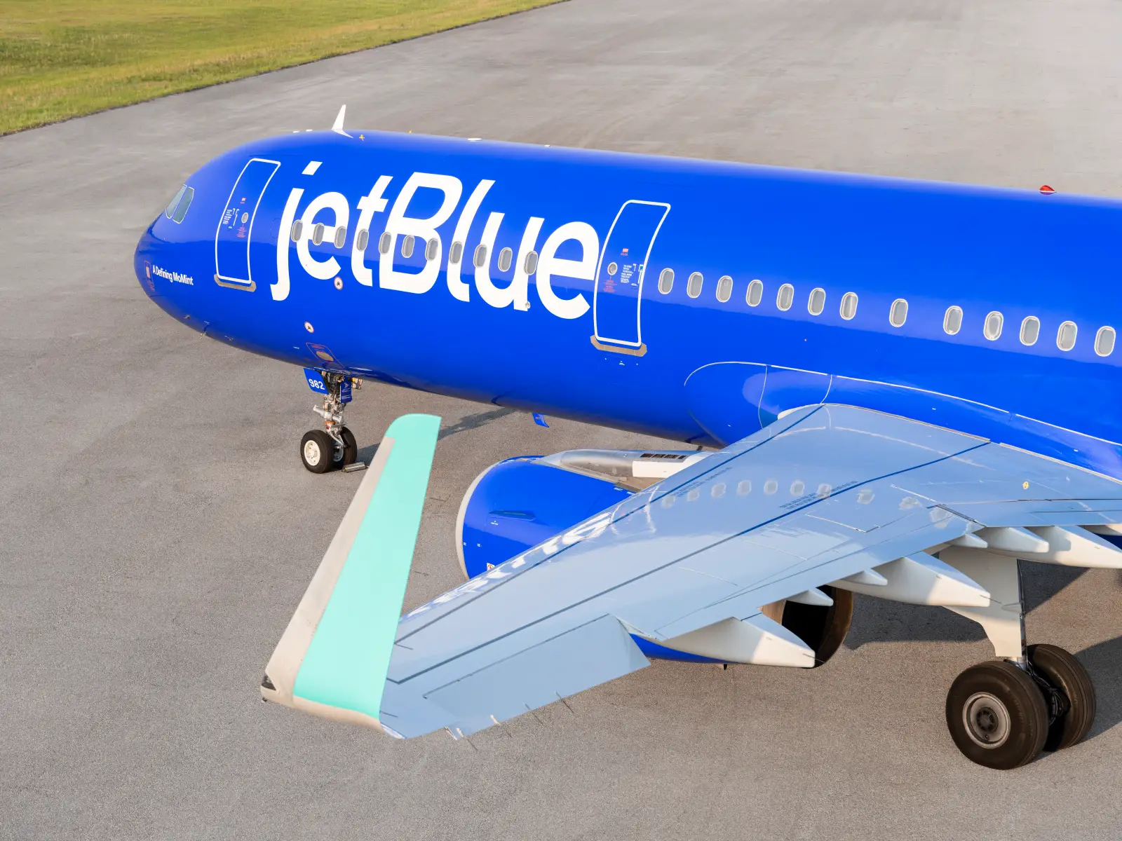 JetBlue Airbus A321 aircraft in blue Mint livery parked on runway