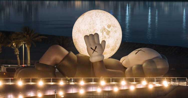 KAWS' companion lifts glowing moon along abu dhabi's waterfront