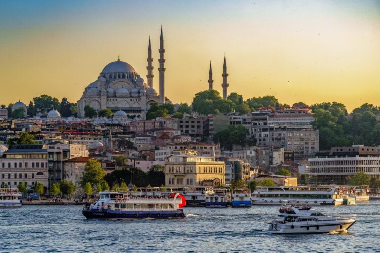 Boats move along the Bosphorus with the Suleymaniye Mosque in the background in Istanbul, Türkiye. (Adobe Stock Photo)
