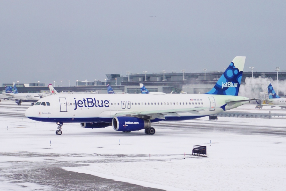 JetBlue plane on snowy runway at JFK Airport
