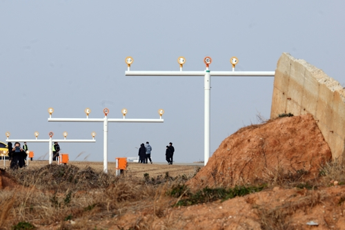the bereaved family leaving behind the scene of the disaster. [Yonhap News]