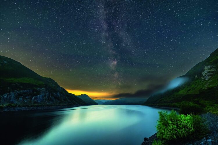 starry night sky over a lake