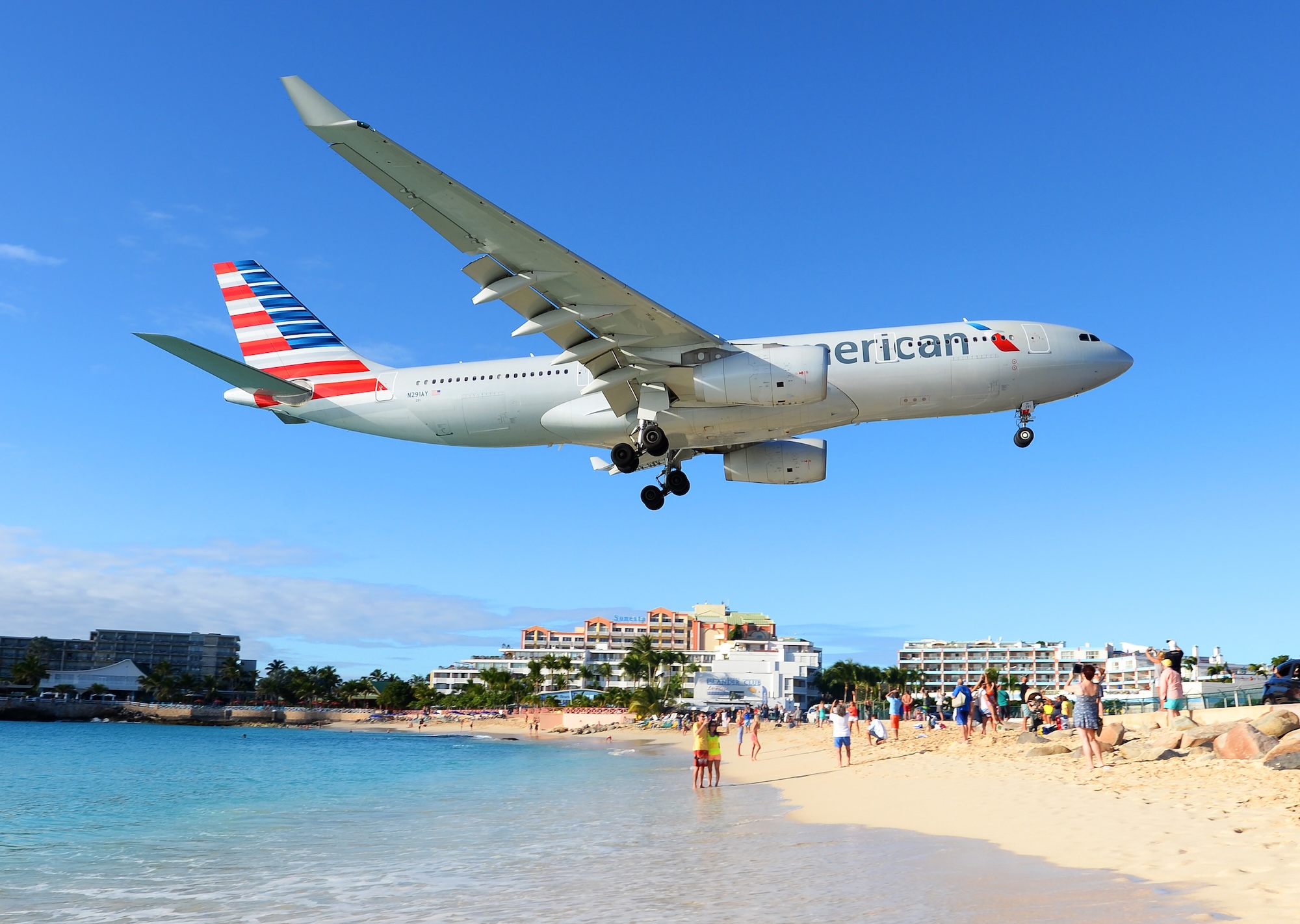 American Airlines aircraft flying over Maho Beach on approach to Princess Juliana Airport.