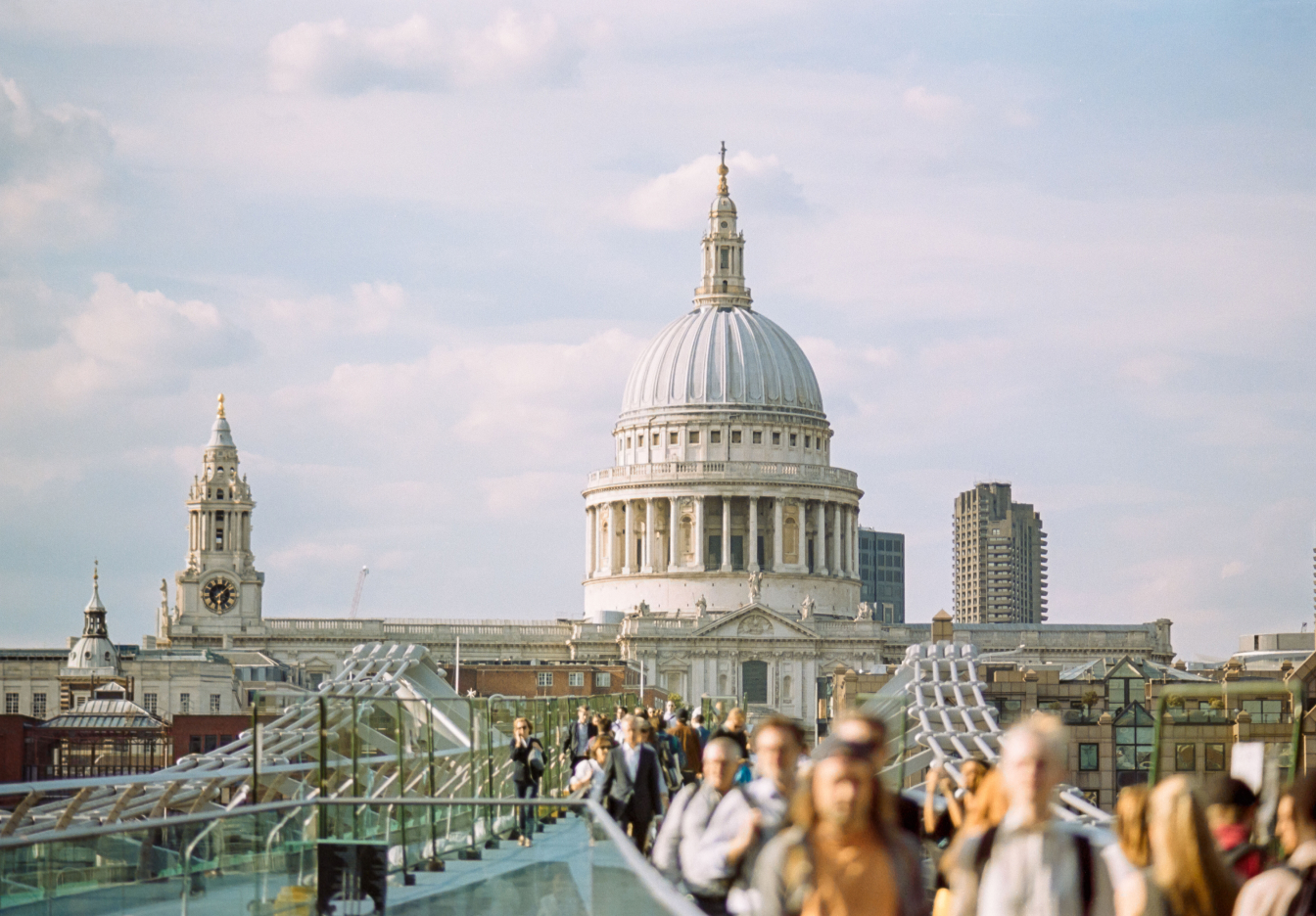 St. Paul's Cathedral in London, England, with pedestrians crossing the Millennium Bridge.