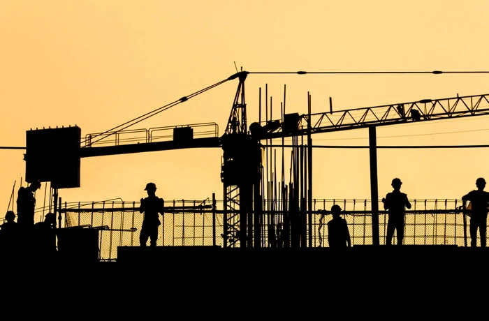 Construction workers on top of a building