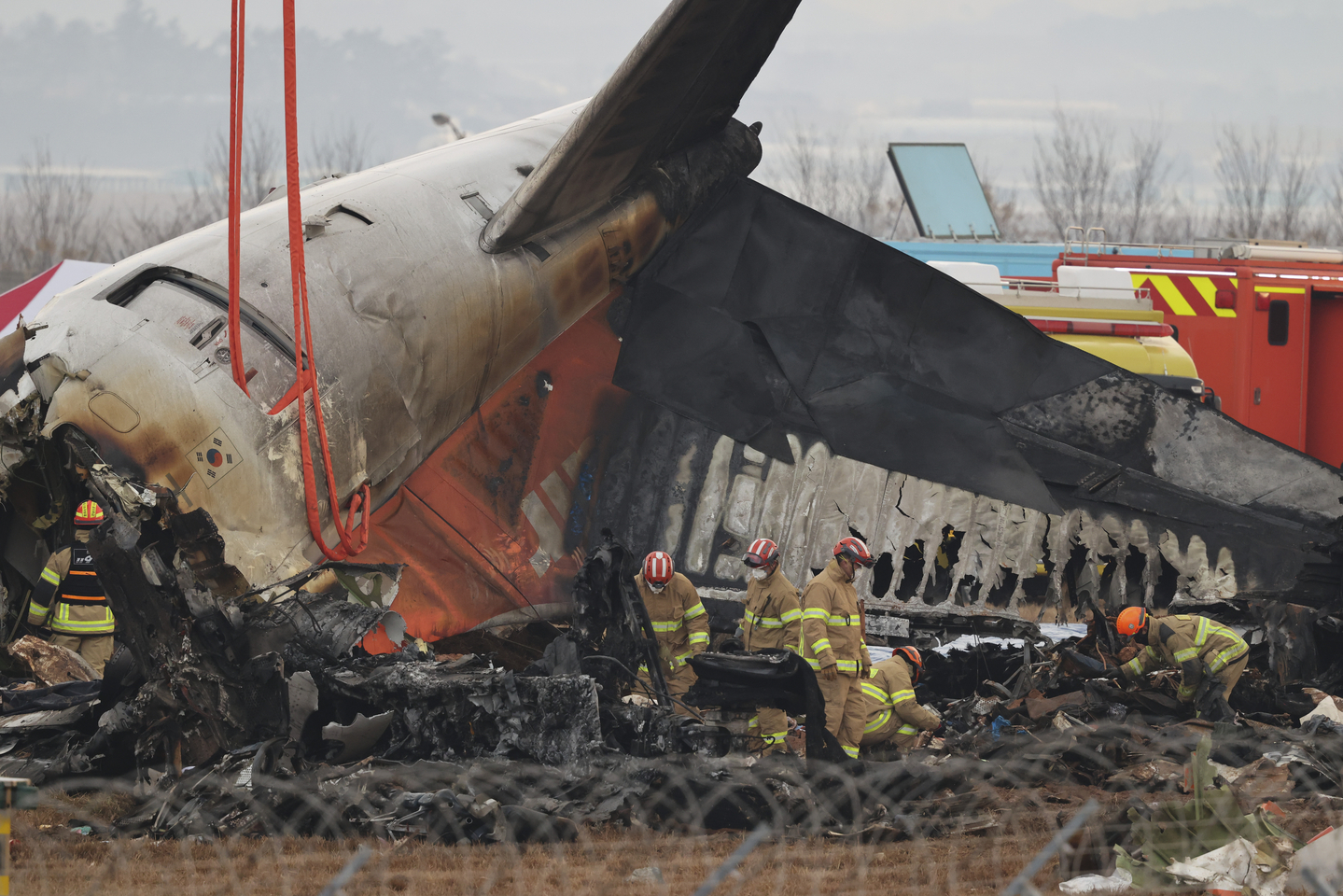 Firefighters conduct search operations at the wreckage site of the Jeju Air aircraft at Muan International Airport in Muan, South Jeolla, on Dec. 30, 2024. [EPA/YONHAP]