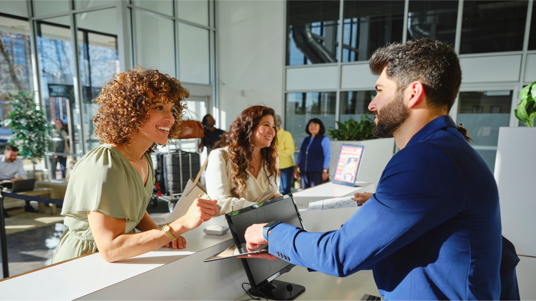 A busy hotel lobby with employees and guests
