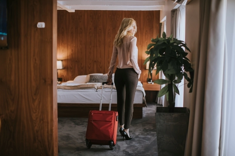 A woman entering a hotel room