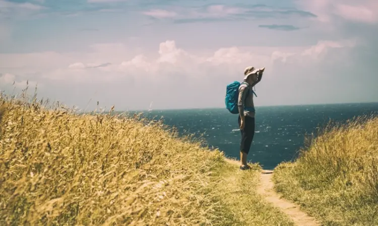 a person hiking on a coastal trail