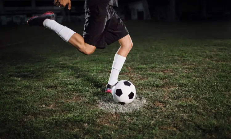 A player kicking a soccer ball