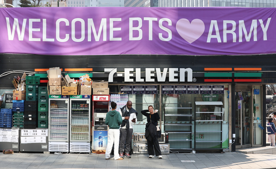 A 7-Eleven convenience store in central Seoul featuring a banner celebrating BTS