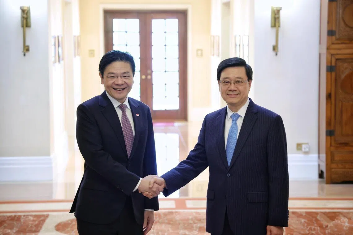 Prime Minister Lawrence Wong shaking hands with Hong Kong Chief Executive John Lee during a meeting and lunch hosted at the Government House in Hong Kong on March 27, 2026. ST PHOTO: KEVIN LIM mfpmhk27