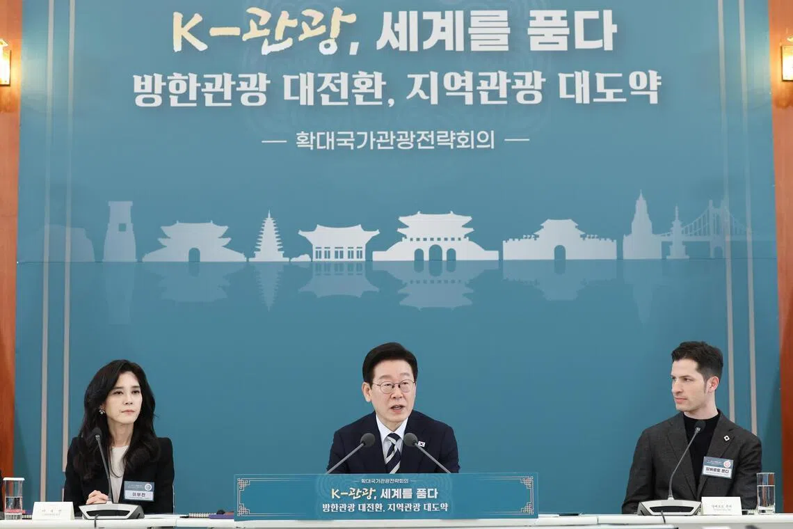 South Korean President Lee Jae Myung (C), chair of the Visit Korea Committee Lee Boo-jin (L) and vice-chief of the Italian Chamber of Commerce and Industry in South Korea Alberto Mondi, attend an expanded meeting on national tourism strategy at the presidential office Cheong Wa Dae in Seoul, South Korea, Feb 25 2026.