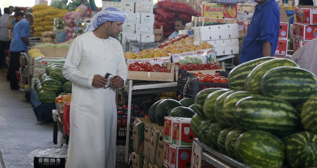 An Emirati man looks at fruits and vegetables at a market during the Muslim fasting month of Ramadan on June 15, 2016 in the Gulf emirate of Dubai. (Photo by KARIM SAHIB / AFP)
