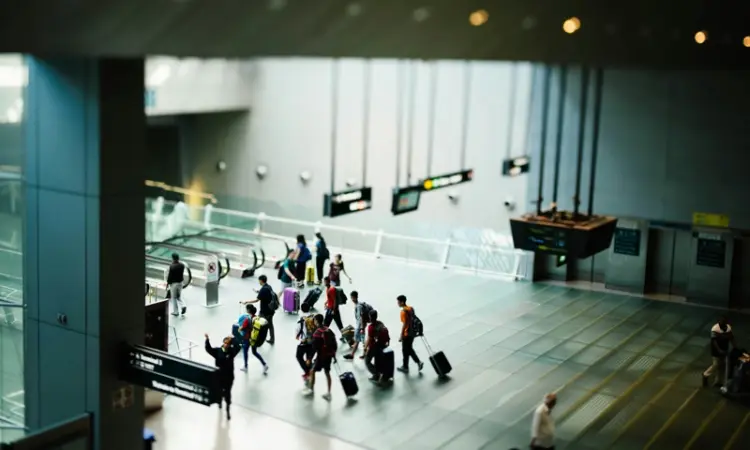 People walking through an airport terminal.