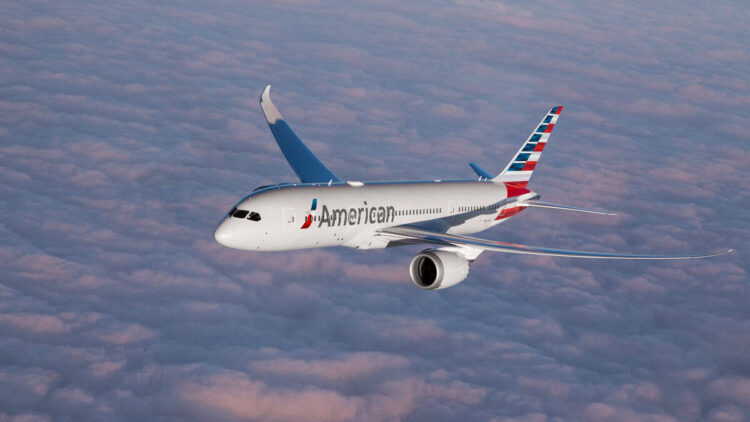American airlines aircraft flying above clouds during daytime.
