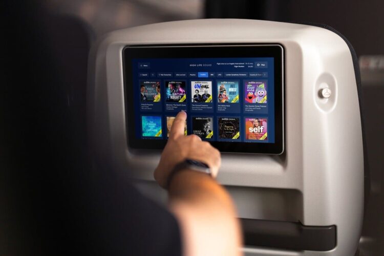In-flight entertainment screen showing audiobooks and podcasts in british airways.