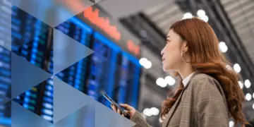 Woman sitting on armchair looking at her mobile