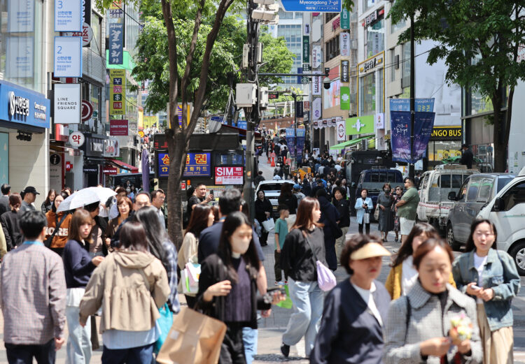 People walk along a street in Myeongdong in Jung District, central Seoul, on April 28, 2025. [YONHAP]
