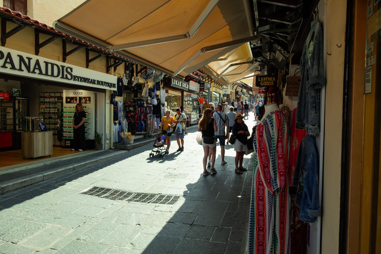 Visitors stroll through the lively shopping streets of Rhodes Old Town, Greece. (Adobe Stock Photo)
