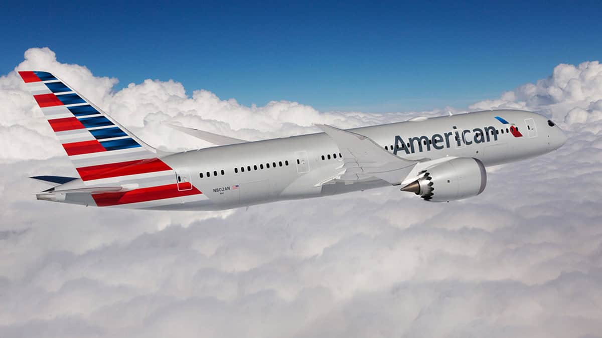 American airlines aircraft in flight over clouds, showcasing airline support dur.